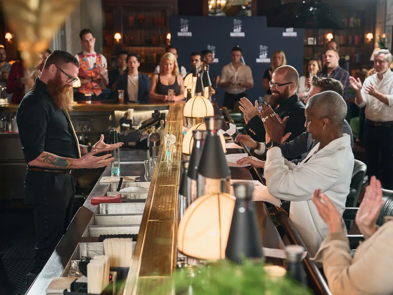 A bartender presenting to guests at a drinks-brand event